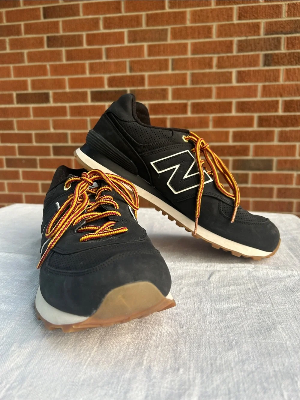 New Balance Men’s Black Sneakers with Tan Sole and Yellow-Orange Laces